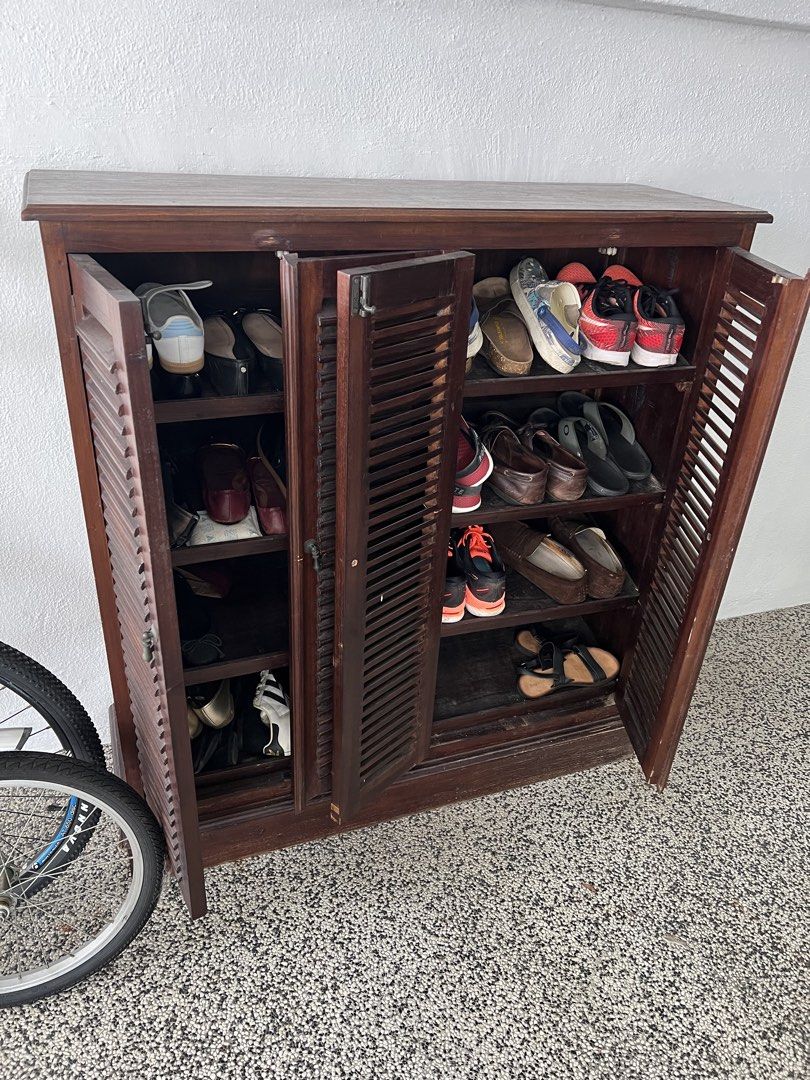 Old teak Shoe Cabinet with Louvered Doors (Category: Shelves, Cabinets & Racks) located in Kuala Lumpur. Submitted by bitsnbeads (Listing ID 1438125820, Image 3). Description: - Solid wooden shoe cabinet - Dark brown color - Four louvered doors - Multiple shelves for shoe storage - Sturdy teak construction - Suitable for entryway or bedroom - Easy-to-open doors with handles All handles/hinges working Note this is old teak (15+ years) so very rare
