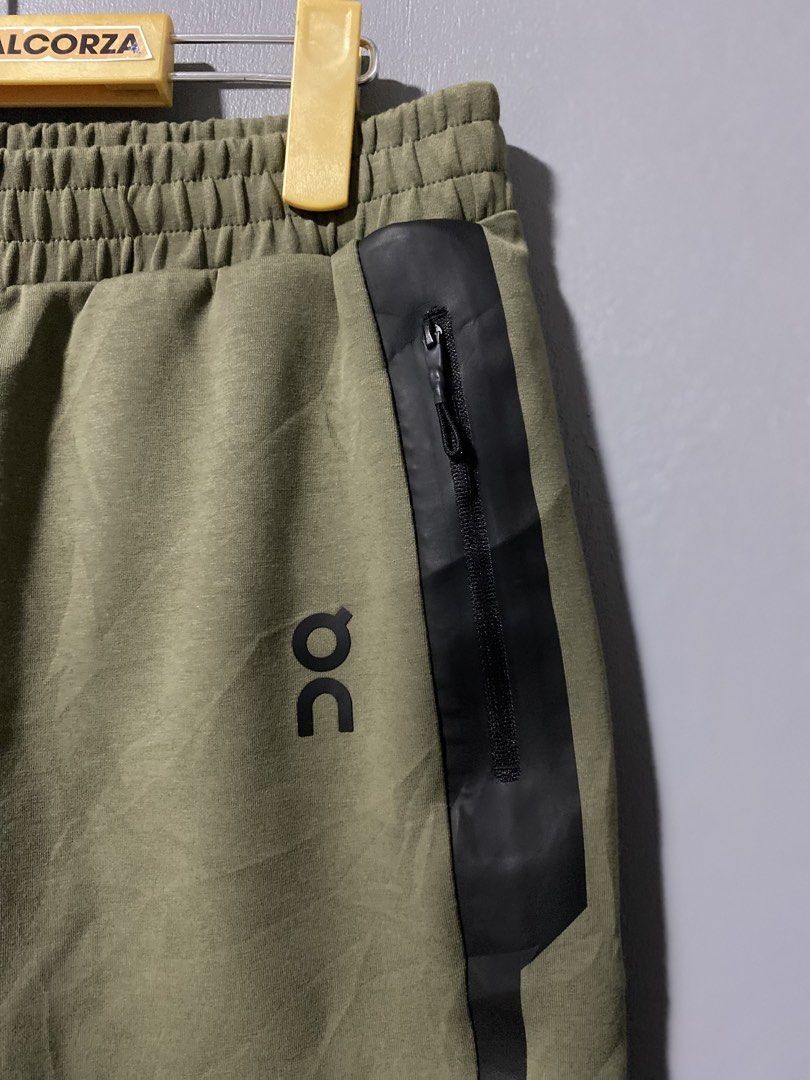 On Running Core Pants (Category: Activewear) located in Tanay. Submitted by judevalcorza (Listing ID 1438128536, Image 3). Description: - On Running Core Pants - Color: Olive Green - Size: S - Design: Black stripe detail, zippered sides - Features: Elastic waistband, On Running logo - Measurements: Waist - 32-34 inches, Length - 36 inches, Leg Opening - 6.5 inches - Made in Vietnam - Excellent Condition - 999 Plus Ship.