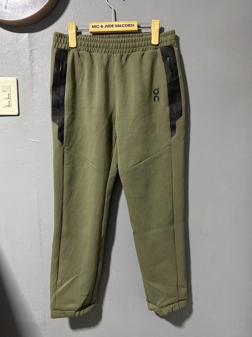 On Running Core Pants (Category: Activewear) located in Tanay. Submitted by judevalcorza (Listing ID 1438128536, Image 1). Description: - On Running Core Pants - Color: Olive Green - Size: S - Design: Black stripe detail, zippered sides - Features: Elastic waistband, On Running logo - Measurements: Waist - 32-34 inches, Length - 36 inches, Leg Opening - 6.5 inches - Made in Vietnam - Excellent Condition - 999 Plus Ship.