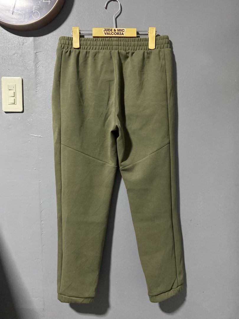 On Running Core Pants (Category: Activewear) located in Tanay. Submitted by judevalcorza (Listing ID 1438128536, Image 2). Description: - On Running Core Pants - Color: Olive Green - Size: S - Design: Black stripe detail, zippered sides - Features: Elastic waistband, On Running logo - Measurements: Waist - 32-34 inches, Length - 36 inches, Leg Opening - 6.5 inches - Made in Vietnam - Excellent Condition - 999 Plus Ship.