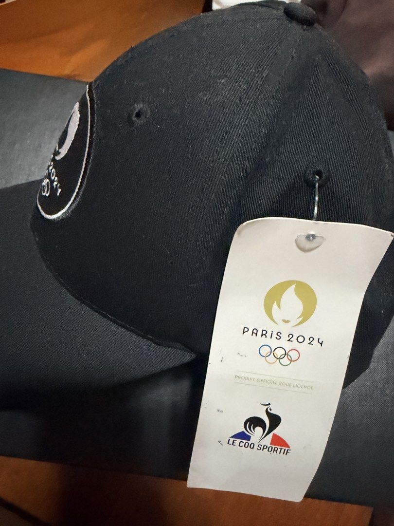 Paris 2024 Le Coq Sportif Cap (Category: Caps & Hats) located in Pasig City. Submitted by sweetd888 (Listing ID 1438147879, Image 3). Description: - Official Paris 2024 cap - Brand: Le Coq Sportif - Color: Black - Material: Cotton - Design: Curved brim, Paris 2024 logo on front - Condition: New with original tag Bought this in Paris during the Paris 2024 Olympics. This is an extra. .