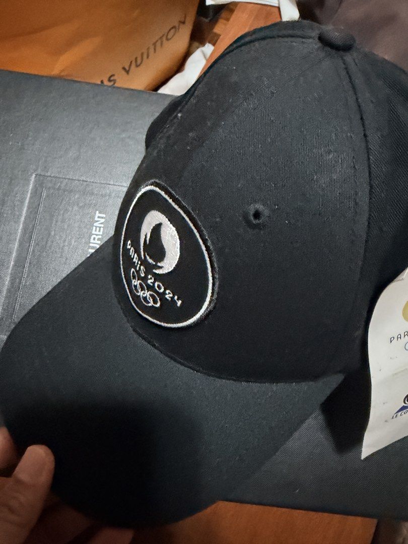 Paris 2024 Le Coq Sportif Cap (Category: Caps & Hats) located in Pasig City. Submitted by sweetd888 (Listing ID 1438147879, Image 2). Description: - Official Paris 2024 cap - Brand: Le Coq Sportif - Color: Black - Material: Cotton - Design: Curved brim, Paris 2024 logo on front - Condition: New with original tag Bought this in Paris during the Paris 2024 Olympics. This is an extra. .