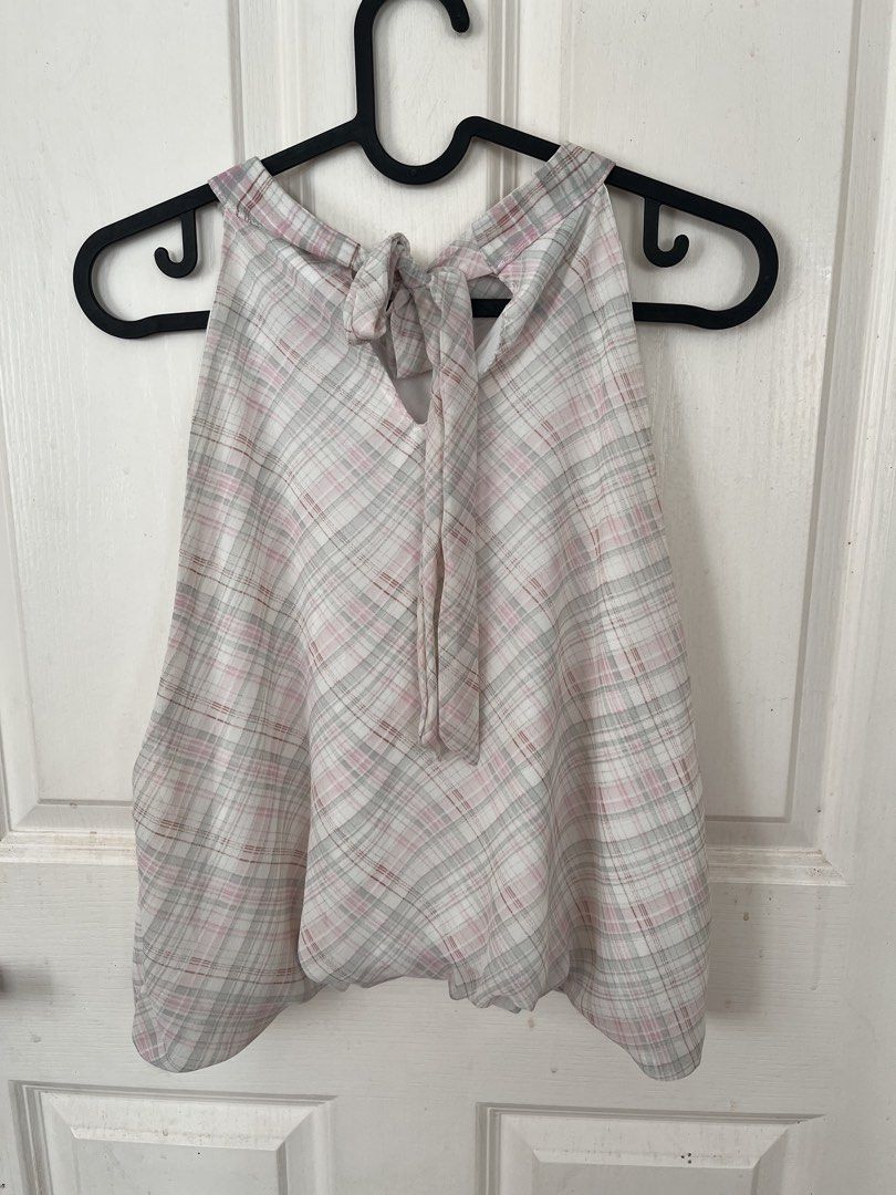 Plaid Halter Top (Category: Sleeveless) located in Bacoor. Submitted by clothestodeclutter (Listing ID 1438143815, Image 2). Description: - Pink, gray, and white plaid halter top - Unique tie-back design - Features a layered, ruffled hem - Lightweight and flowy fabric - Ideal for warm weather.