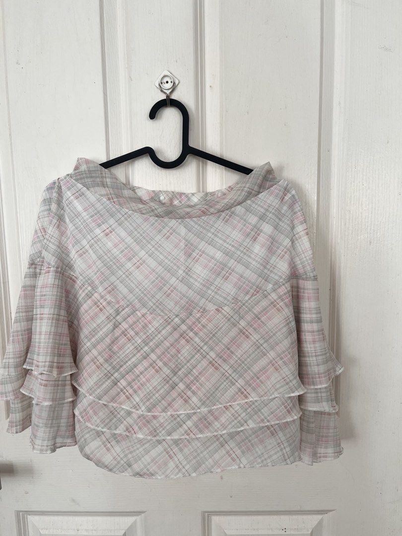 Plaid Halter Top (Category: Sleeveless) located in Bacoor. Submitted by clothestodeclutter (Listing ID 1438143815, Image 3). Description: - Pink, gray, and white plaid halter top - Unique tie-back design - Features a layered, ruffled hem - Lightweight and flowy fabric - Ideal for warm weather.