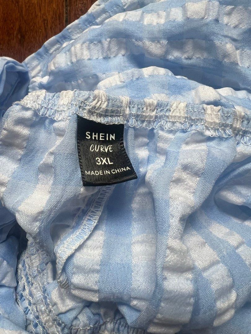 PLUS SIZE Shein 3XL Plaid Backless Dress (Category: Dresses) located in Mandaluyong City. Submitted by kkairi (Listing ID 1438240841, Image 3). Description: - Size: 3XL - Pattern: Blue and white plaid - Features: Smocked bodice, criss-cross back straps, bow detail - Perfect for casual and beach wear :).