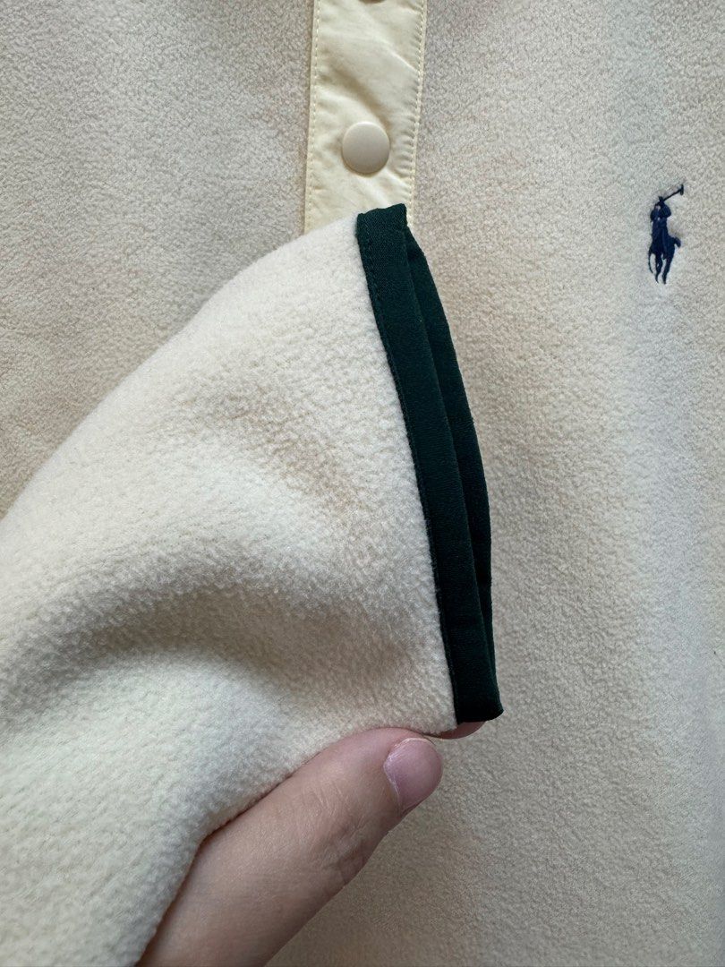 Polo Ralph Lauren Performance Fleece Sweater (Category: Coats, Jackets and Outerwear) located in Caloocan City. Submitted by izzie_finds (Listing ID 1438112031, Image 3). Description: - Polo Ralph Lauren Performance fleece sweater - Color: Cream - Size: Small - Features: - High collar with button closure - Embroidered logo - Side pockets with zippers - Dark green trim on cuffs and hem.