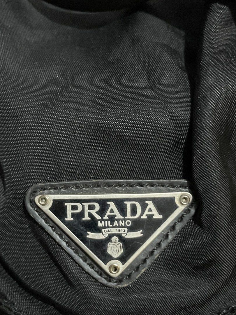 Prada Tessuto Nylon Backpack (Category: Luxury Bags & Wallets) located in La Trinidad. Submitted by outfit_chic.101 (Listing ID 1438264088, Image 3). Description: The vintage Prada Tessuto Nylon Backpack (first introduced in 1984 under Miuccia Prada) [11] is highly sought after on the secondhand market. Because older models lack modern anti-counterfeiting features, verifying authenticity requires inspecting specific production details..
