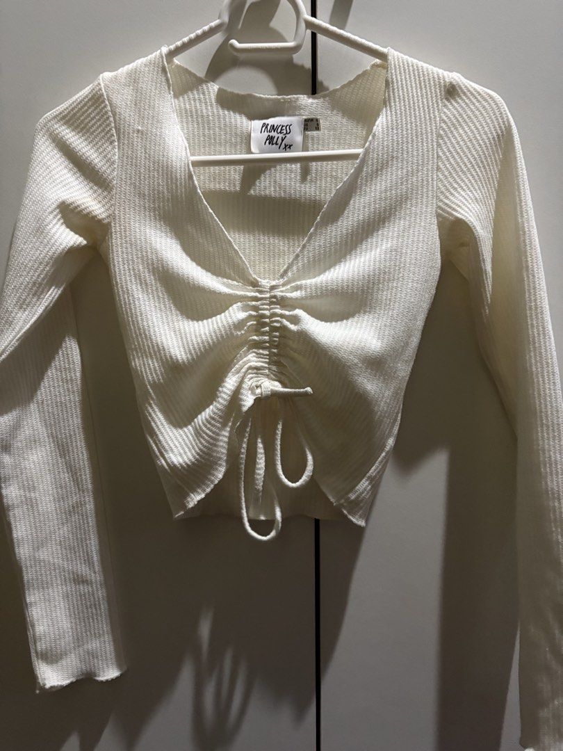 Princess Polly Pinch Me Top (Category: Others Tops) located in Quezon City. Submitted by strmlnng (Listing ID 1438216730, Image 1). Description: - Princess Polly white ribbed crop top - V-neckline with drawstring - Long sleeves - Cropped style - Ribbed knit fabric Retailed at around ₱2,500 converted. Drop your offers. Please manage expectation, has yellowish stains..