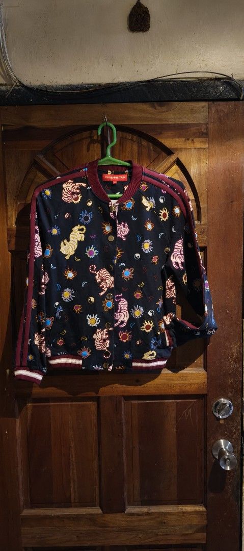 Printed Bomber Jacket (Category: Activewear) located in Caloocan City. Submitted by abykilo99-61094 (Listing ID 1438300518, Image 1). Description: - Unique tiger and floral print - Dark base color with burgundy accents - Button-up front - Ribbed hem - Lightweight design - Suitable for layering.