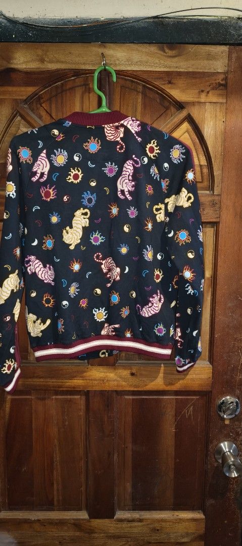 Printed Bomber Jacket (Category: Activewear) located in Caloocan City. Submitted by abykilo99-61094 (Listing ID 1438300518, Image 2). Description: - Unique tiger and floral print - Dark base color with burgundy accents - Button-up front - Ribbed hem - Lightweight design - Suitable for layering.