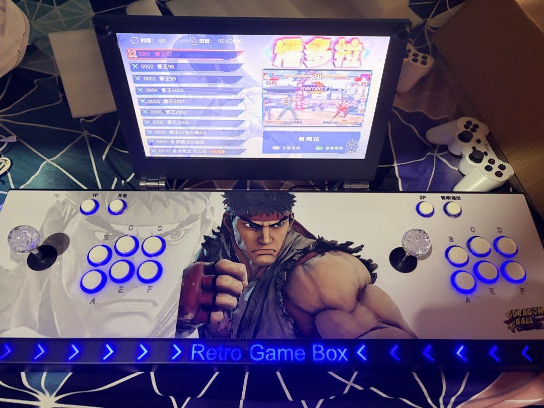Retro Game Box Arcade Console with Screen (Category: Others) located in Makati City. Submitted by royalbear_9ad8f9 (Listing ID 1438161509, Image 1). Description: - Retro Game Box arcade console - Ryu design - Built-in screen - Includes two controllers - Features a variety of retro games - Supports 1P and 2P gameplay - Buttons and joysticks for control - Includes AC adapter.