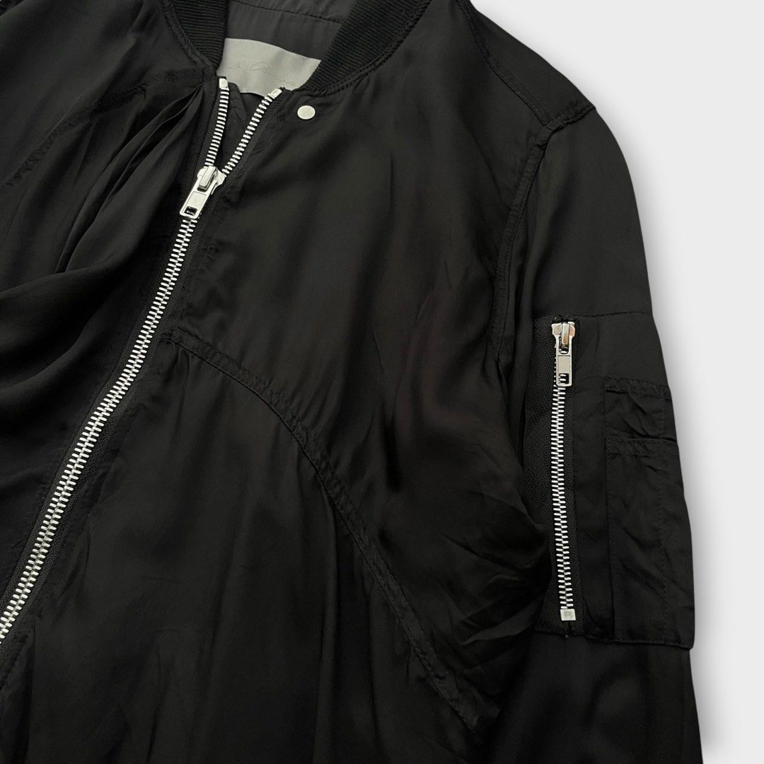 Rick Owens S/S16 - Cyclops - Zipped Ripple Flight Jacket (Category: Coats, Jackets and Outerwear) located in Los Banos. Submitted by declutterking (Listing ID 1438285237, Image 3). Description: Size 36 on tag Long sleeved viscose bomber jacket detailed with stand up collar, zipped arm pocket, asymmetric stitchings to form drapes and rib knitted collar and waistline. Front zip fastening. Fully lined. It is part of Cyclops S/S 16 collection. Slashe