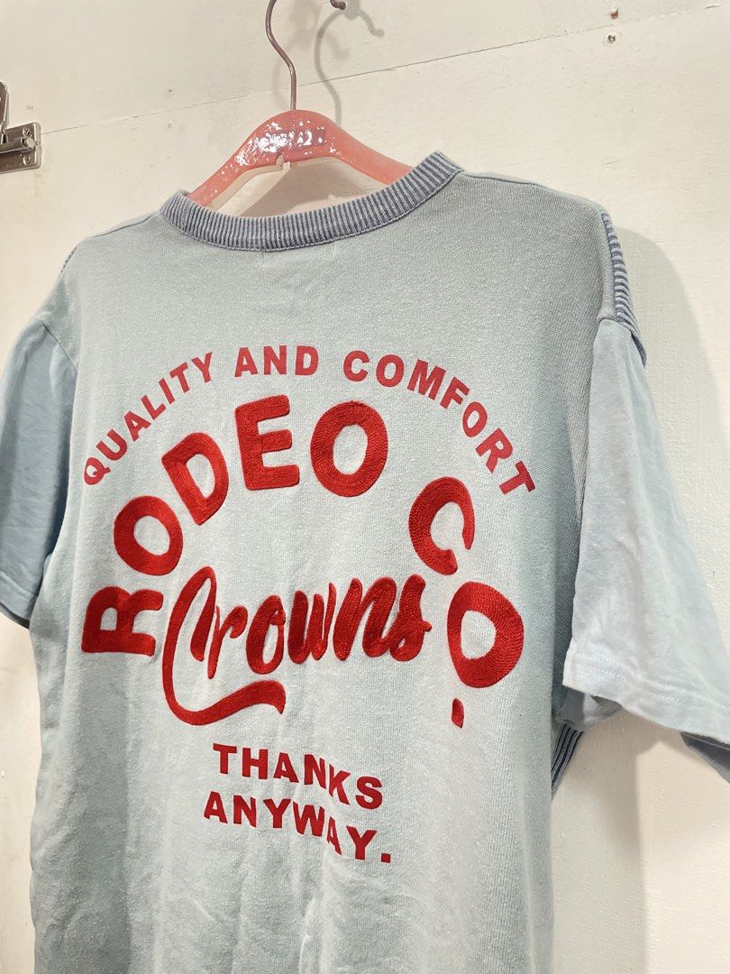 Rodeo Crowns Co. Blue T-shirt (Category: Tshirts & Polo Shirts ) located in Manila. Submitted by ledithgo (Listing ID 1438282002, Image 3). Description: - Rodeo Crowns Co. T-shirt - Light blue color - Striped pocket and accents - Red logo on back with "QUALITY AND COMFORT" and " ANYWAY" - Relaxed fit - Ribbed neckline - Short sleeves.