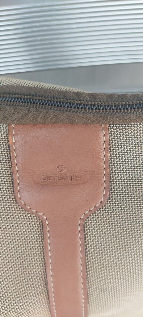 Samsonite Shoulder Bag (Category: Luxury Bags & Wallets) located in Batangas. Submitted by roams (Listing ID 1438185669, Image 2). Description: - Samsonite shoulder bag - Tan canvas exterior - Brown leather accents - Zippered closure - Metal ring detail - Minor wear present with signs of use see photos wala na puller sa main compartment pero nasizipper pa din, pwd lagyan pa ng puller just pm.