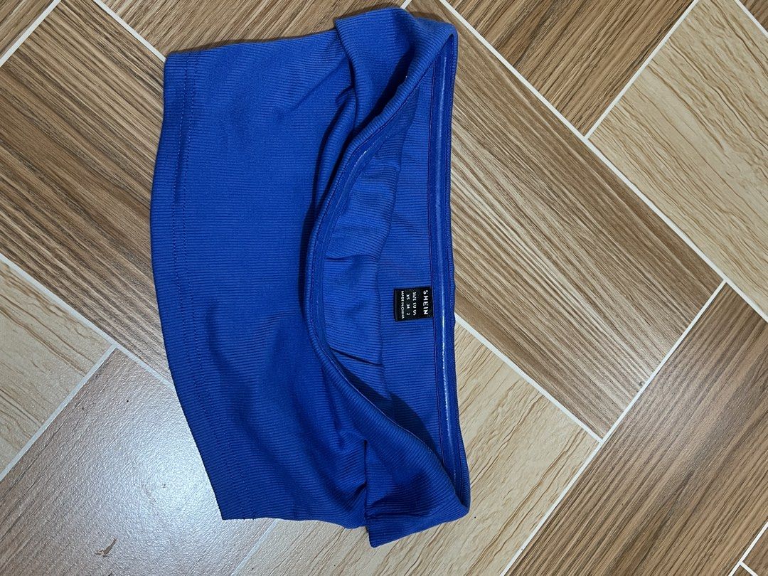 Shein Blue Tube Top (Category: Others Tops) located in Baguio. Submitted by izzy1234123 (Listing ID 1438150426, Image 2). Description: - Shein tube top in a bright blue color. - Features a stylish ribbed texture. - Designed for a comfortable fit. - Versatile piece, great for casual outfits. - Perfect for layering different looks..