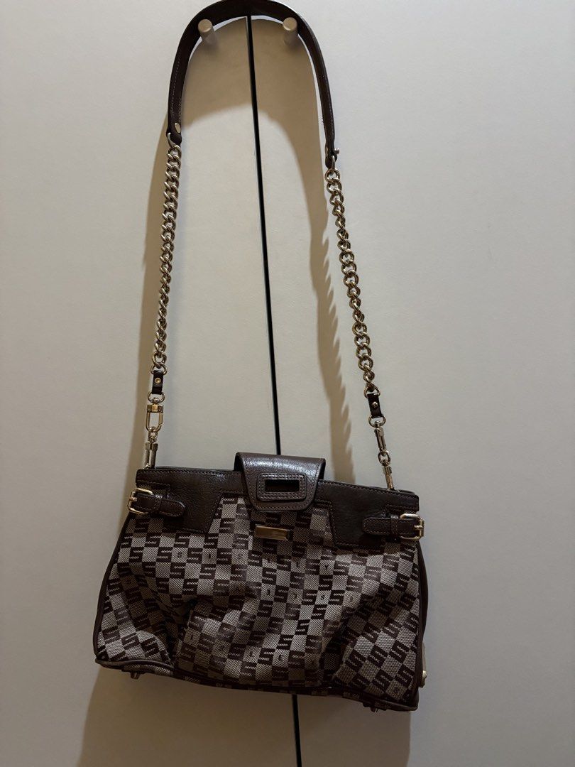 Sisley Italy Brown Shoulder Bag (Category: Shoulder Bags) located in Quezon City. Submitted by strmlnng (Listing ID 1438222541, Image 2). Description: - Sisley Italy shoulder bag - Brown color - Beige checkered pattern - Flap closure with gold-tone metal accent - Detachable chain strap - Zippered interior pocket - Features Sisley Italy label inside Drop your offers. Kindly manage expectation. Thanks!.