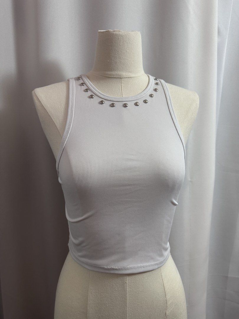 ‼️AVAIL - Studded Tank White Ribbed Crop Top with Studs (Category: Others Tops) located in Baguio. Submitted by st0nefox (Listing ID 1438287827, Image 2). Description: - White crop top - Ribbed texture - Round neckline with silver studs - Sleeveless - Comfortable, stretchy fabric - Perfect for warmer weather - Pairs well with high-waisted bottoms.