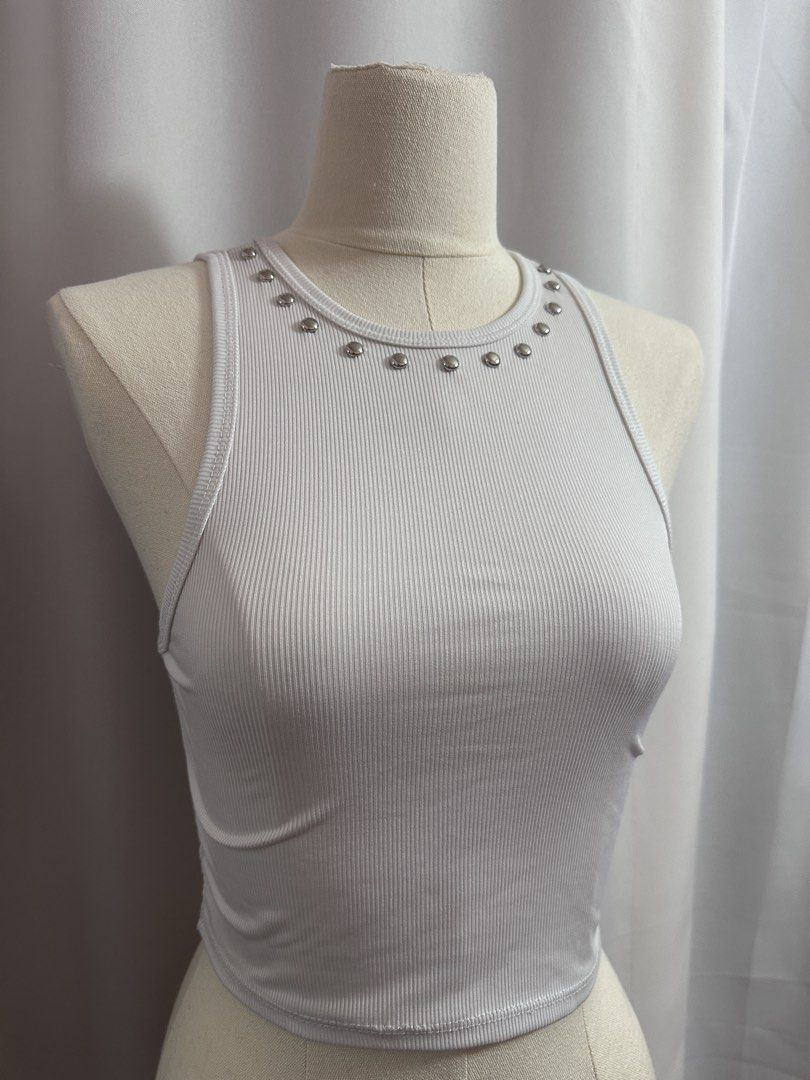 ‼️AVAIL - Studded Tank White Ribbed Crop Top with Studs (Category: Others Tops) located in Baguio. Submitted by st0nefox (Listing ID 1438287827, Image 3). Description: - White crop top - Ribbed texture - Round neckline with silver studs - Sleeveless - Comfortable, stretchy fabric - Perfect for warmer weather - Pairs well with high-waisted bottoms.