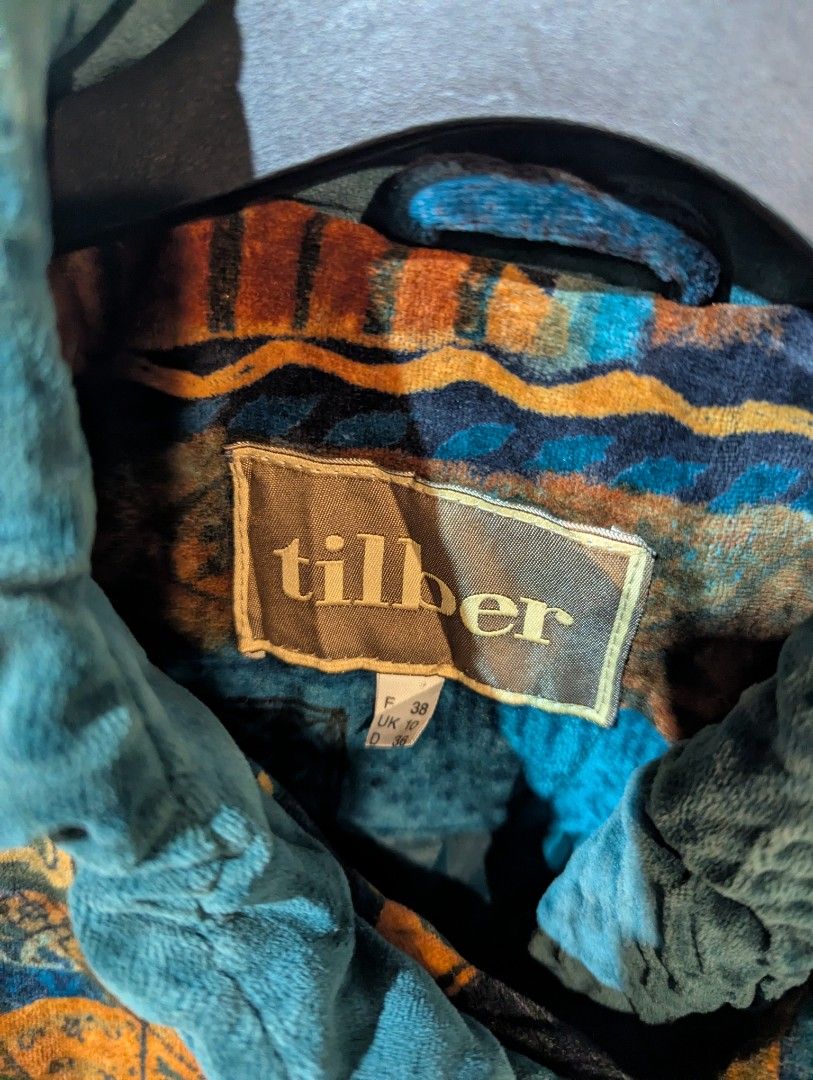Tilber Patchwork Coat (Category: Coats, Jackets and Outerwear) located in Muar. Submitted by selamart_ (Listing ID 1438247688, Image 2). Description: Tilber coat features a unique patchwork design in shades of teal, brown, and orange. It has a velvet collar and three buttons. The coat is a size 38. The inner lining has a patterned design. It is a vintage piece with a distinctive style. Free shipping peninsular Malaysia..