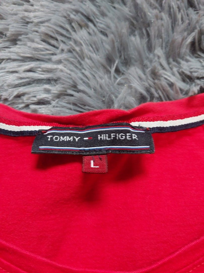 Tommy Hilfiger Red T-shirt (Category: Shirts) located in Calasiao. Submitted by _annetastic_ (Listing ID 1438209663, Image 2). Description: - Red Tommy Hilfiger T-shirt - Size: can fit small up to semi large Level up your everyday fit with this bold red Tommy Hilfiger shirt ❤️‍🔥 Clean design, comfy feel. Pair it with jeans or white pants for that fresh, put-together vibe without effort. - Fabric: 100% cotton preloved , decluttering and twice use
