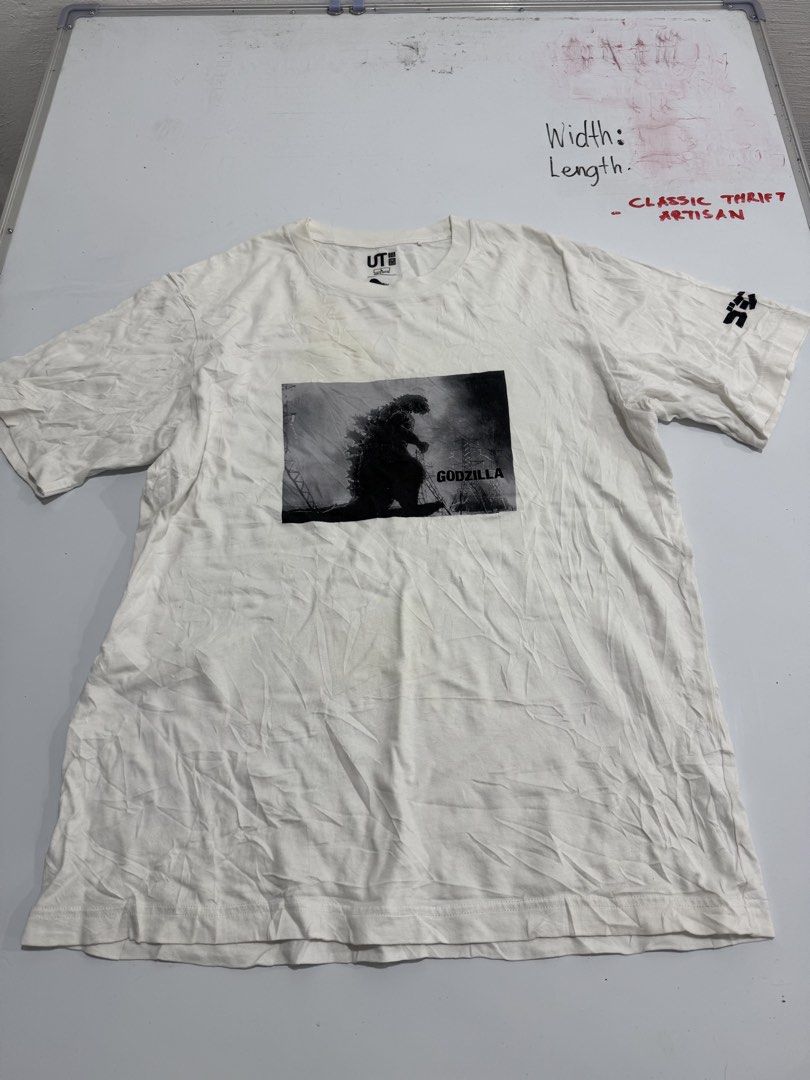 Uniqlo UT Godzilla Graphic Tee (Category: Tshirts & Polo Shirts ) located in Cebu City. Submitted by oryenz (Listing ID 1438263957, Image 1). Description: - Uniqlo UT t-shirt - Features a Godzilla graphic - White, short-sleeved - Graphic on the sleeve - Uniqlo logo on collar - Size not specified.