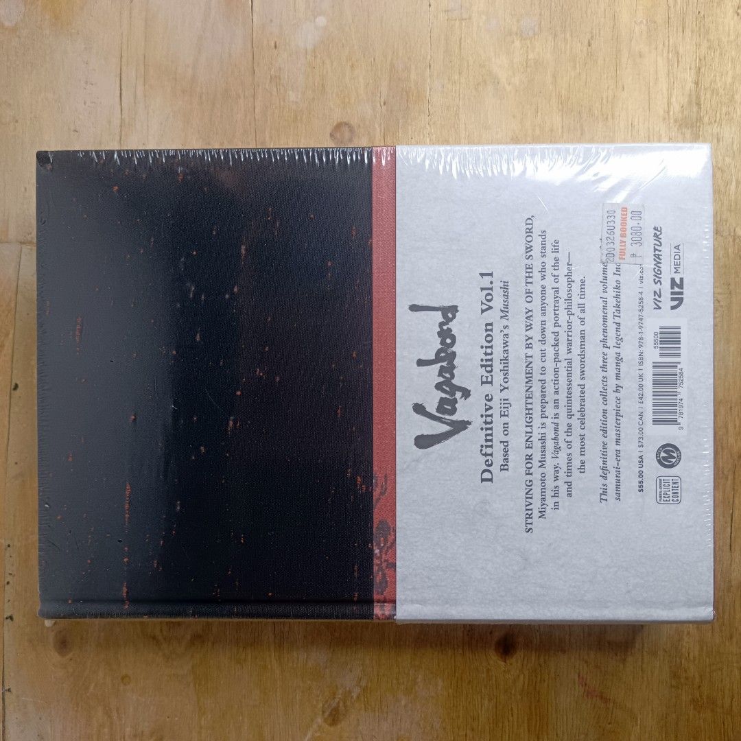 Vagabond Definitive Edition Vol. 1 (Category: Comics & Manga) located in Manila. Submitted by shelfenjoyment (Listing ID 1438297448, Image 2). Description: Vagabond Definitive Edition Vol. 1 by Takehiko Inoue. This edition is still sealed in its original packaging. The book features a striking cover design with gold lettering and a detailed illustration. The spine also displays the title, author, and volume number. A red ribbon is included as a b