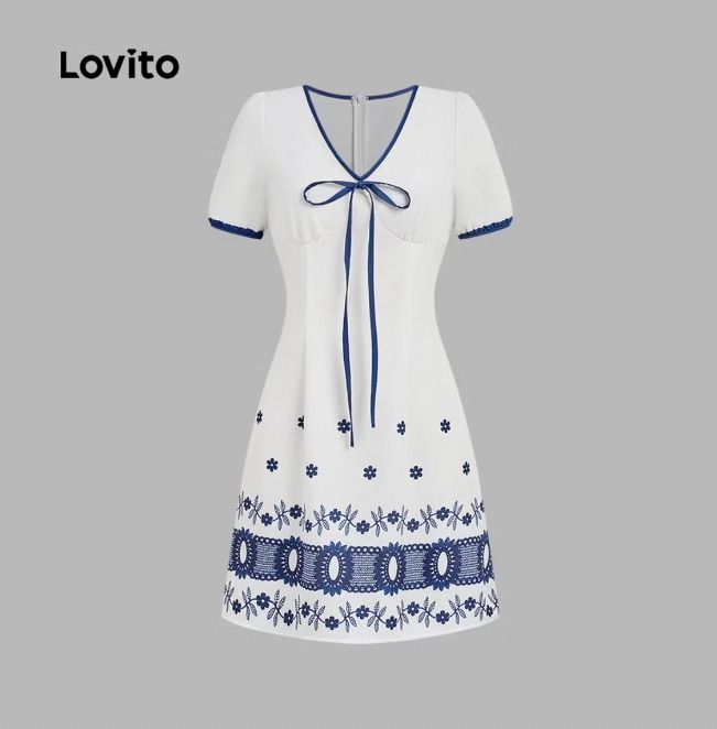 White Dress with Blue Accents (Category: Dresses) located in Davao. Submitted by iahleah (Listing ID 1438295230, Image 1). Description: - White V-neck dress - Blue trim on neckline, sleeves, and tie - Adorned with blue floral and decorative patterns at the hem - Fitted bodice - Slightly flared skirt - Made of lightweight fabric.