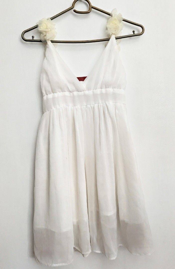 White Dress with Floral Straps (Category: Dresses) located in Cebu City. Submitted by wearthyy (Listing ID 1438190502, Image 1). Description: - White dress with floral strap accents - V-neckline - Flowing, lightweight design - Soft, sheer fabric - Cinched waist for a flattering fit - Perfect for warm weather.