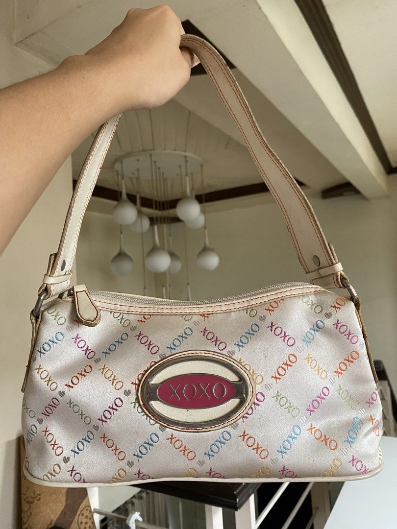 XOXO Shoulder Bag (Category: Shoulder Bags) located in Manila. Submitted by kidulthings (Listing ID 1438148831, Image 3). Description: - XOXO shoulder bag - White base with colorful XOXO print - Zip closure - Shoulder strap - Metallic XOXO logo detail - Minor discoloration on the bottom.