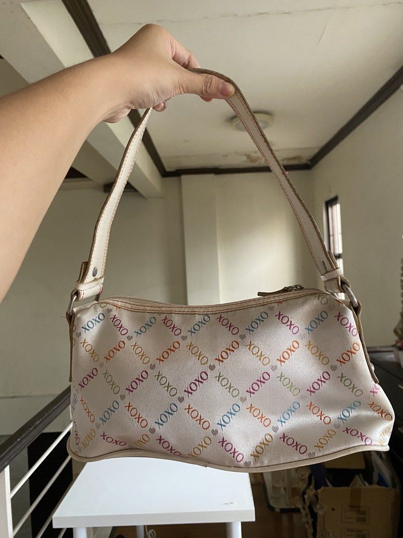 XOXO Shoulder Bag (Category: Shoulder Bags) located in Manila. Submitted by kidulthings (Listing ID 1438148831, Image 2). Description: - XOXO shoulder bag - White base with colorful XOXO print - Zip closure - Shoulder strap - Metallic XOXO logo detail - Minor discoloration on the bottom.