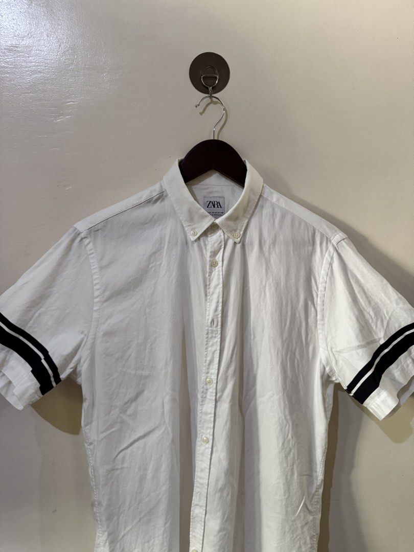 Zara White short sleeve button down shirt (Category: Tshirts & Polo Shirts ) located in Bacolod City. Submitted by bi.fl (Listing ID 1438141456, Image 3). Description: Zara White short sleeve button down shirt M on tag / Relaxed Fit 21.5x29 No issues / Ang ganda nito sa personal color and tela / need lang plantsa Pristine condition both color and fabric. No discoloration. 🧾Mode of payment: GCash or Bank Transfer 📸Color may vary due to lighting 