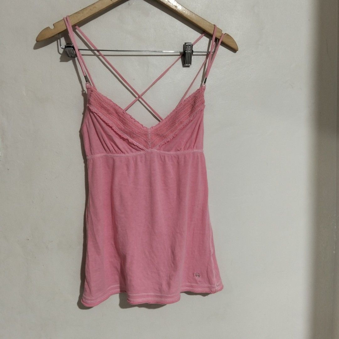 Abercrombie baby doll Top S (Category: Sleeveless) located in Subic. Submitted by tintindera (Listing ID 1438431291, Image 1). Description: - Abercrombie & Fitch tank top - Pink color - Criss-cross back design - Lace detail on neckline - Embroidered logo - Size: S - Made in Macau.