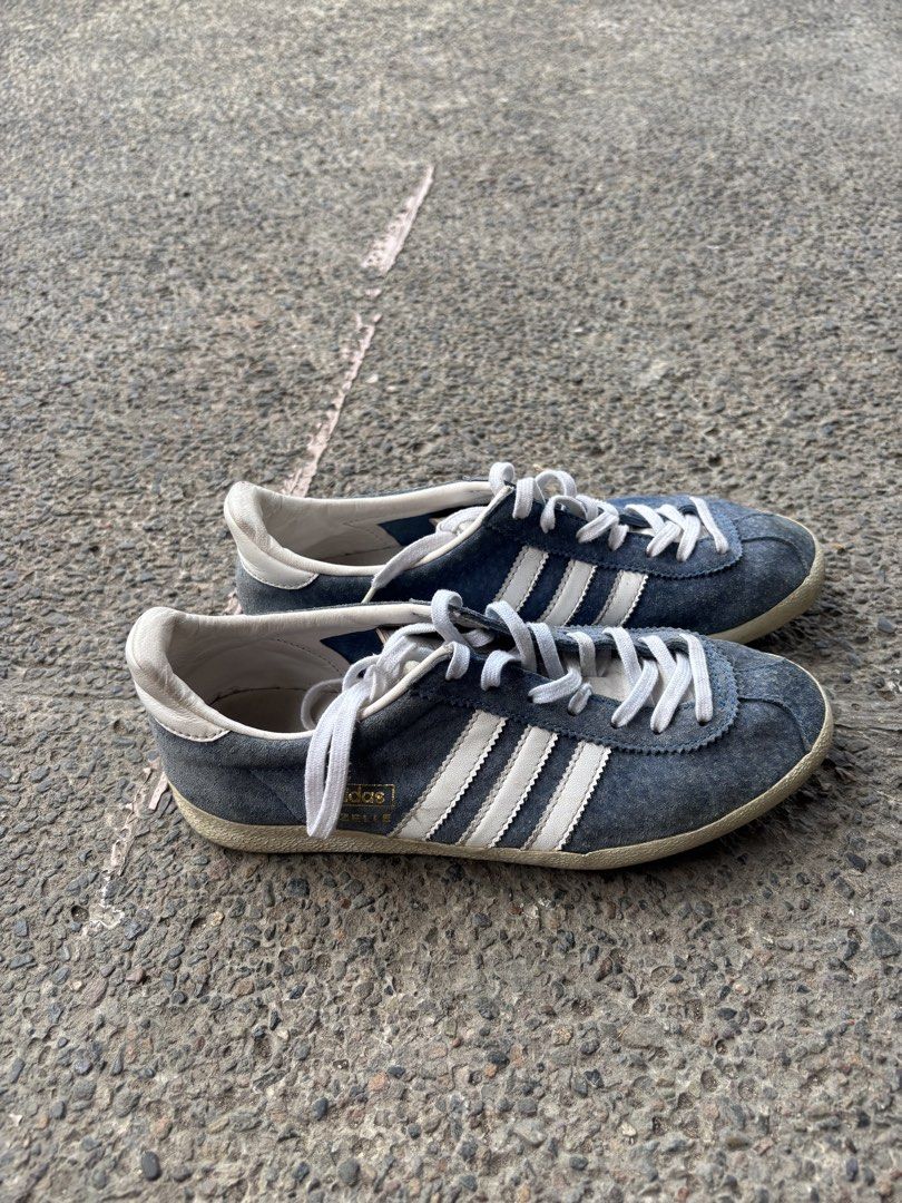Adidas Gazelle Blue Sneakers (Category: Sneakers) located in Pasig City. Submitted by bcp1122 (Listing ID 1438325497, Image 1). Description: - Adidas Gazelle sneakers Can fit up to 23 cm Very negotiable - Color: Blue with white stripes - Features white laces and sole - Adidas logo visible - Signs of wear on soles - Stylish for everyday wear - issues: old From seller who gets from US RFS: don't use.