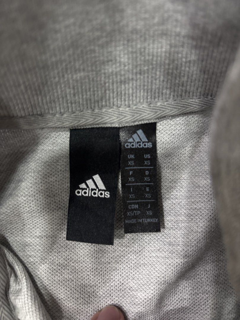 Adidas Polo Shirt XS (Category: Tshirts & Polo Shirts ) located in Manila. Submitted by colin92421 (Listing ID 1438371076, Image 3). Description: - Adidas grey polo shirt - Size: XS - Features a mock neck collar - Three-button placket - Short sleeves - Adidas logo on chest and sleeve - Made in Turkey.