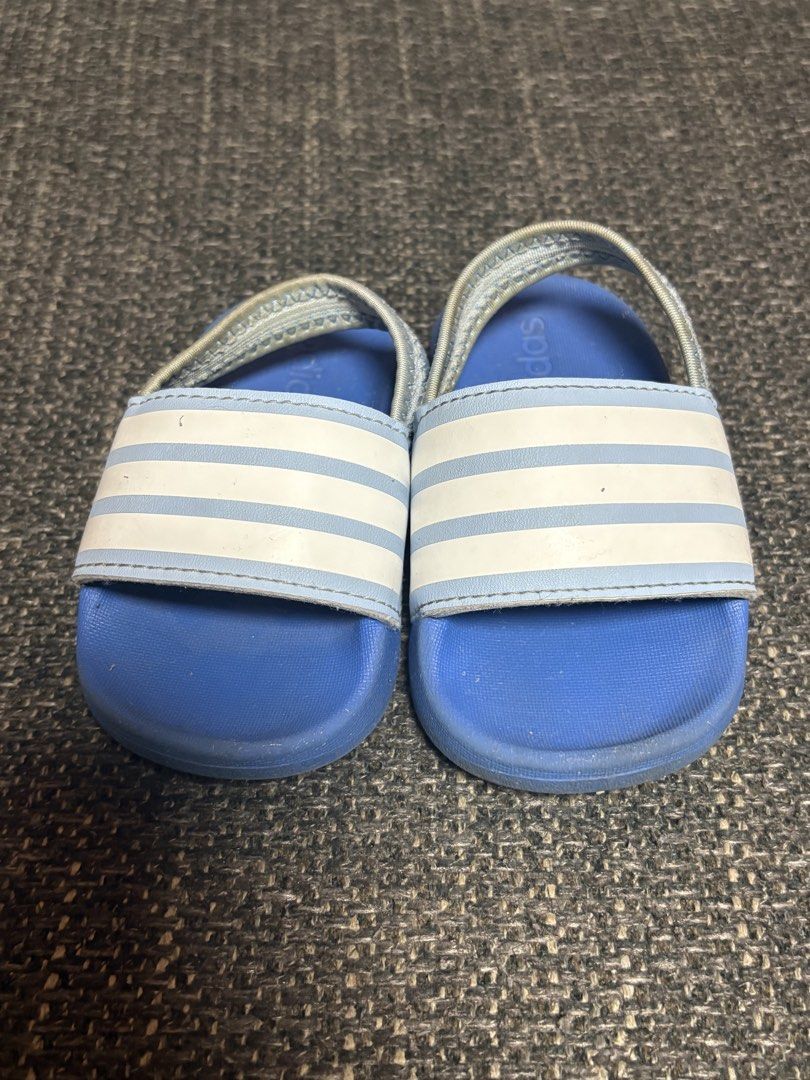 Adidas Toddler Sandals Blue White (Category: Babies & Kids Fashion) located in Mabalacat. Submitted by fhey.09 (Listing ID 1438419981, Image 1). Description: - Adidas toddler sandals - Color: Blue and white - Size: 4K - Features: Back strap for security - Made in Vietnam - Condition: Some wear on soles.