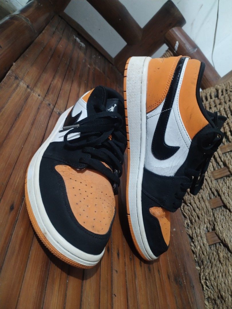 Air Jordan 1 Low - Orange Black (Category: Sneakers) located in Bacoor. Submitted by egogan (Listing ID 1438385826, Image 1). Description: - Air Jordan 1 Low sneakers - Color: Orange, black, and white - Features Nike swoosh and Jordan logo - Black laces - White midsole - Orange toe box and heel - Black and white panels - Iconic design.