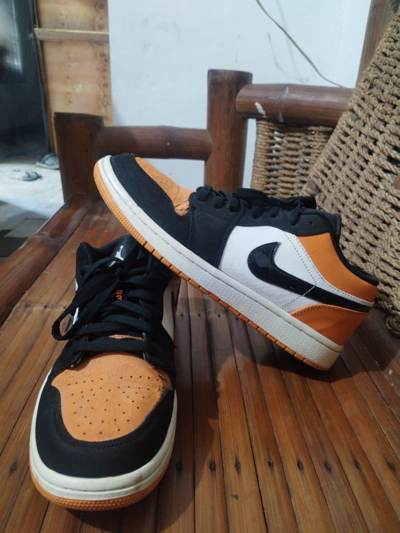 Air Jordan 1 Low - Orange Black (Category: Sneakers) located in Bacoor. Submitted by egogan (Listing ID 1438385826, Image 3). Description: - Air Jordan 1 Low sneakers - Color: Orange, black, and white - Features Nike swoosh and Jordan logo - Black laces - White midsole - Orange toe box and heel - Black and white panels - Iconic design.