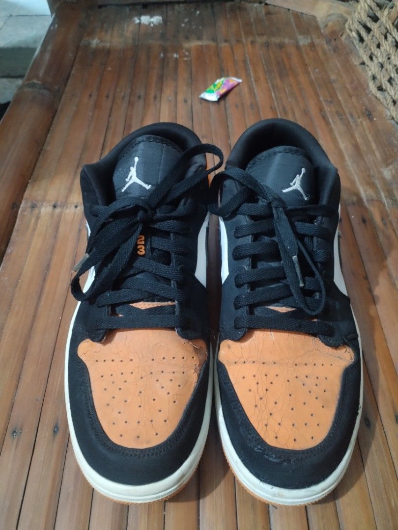 Air Jordan 1 Low - Orange Black (Category: Sneakers) located in Bacoor. Submitted by egogan (Listing ID 1438385826, Image 2). Description: - Air Jordan 1 Low sneakers - Color: Orange, black, and white - Features Nike swoosh and Jordan logo - Black laces - White midsole - Orange toe box and heel - Black and white panels - Iconic design.