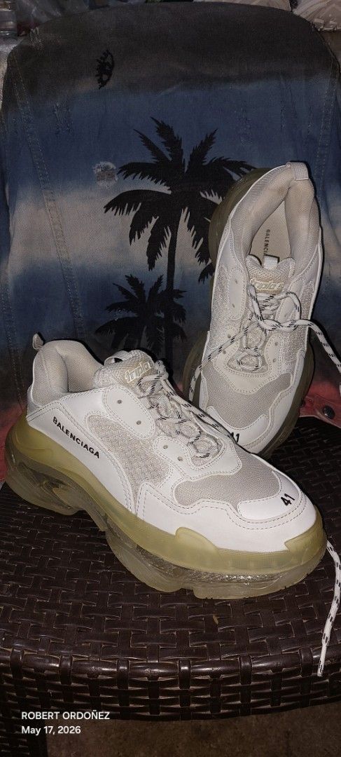 Balenciaga Triple S Sneakers White (Category: Sneakers) located in Candelaria. Submitted by RHOBZ29 (Listing ID 1438472077, Image 1). Description: - Balenciaga Triple S sneakers - Color: White - Size: 41 - Chunky sole design - Balenciaga logo detail - Mesh upper - Translucent yellow soles - White laces - Made in China.