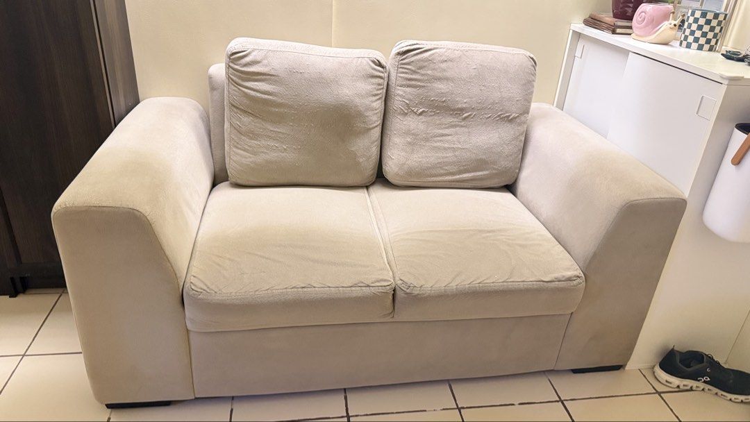 Beige 2-Seater Sofa (Category: Sofas) located in Manila. Submitted by ishiki.mnld (Listing ID 1438473070, Image 2). Description: - Beige 2-seater sofa - Includes two removable cushions - Comfortable design - Soft, textured fabric - Neutral color, easy to match - Ideal for living rooms and small spaces Issue - sira na po yung zipper nung 2 backpillow. Pero di naman halata pag nakabaligtad..