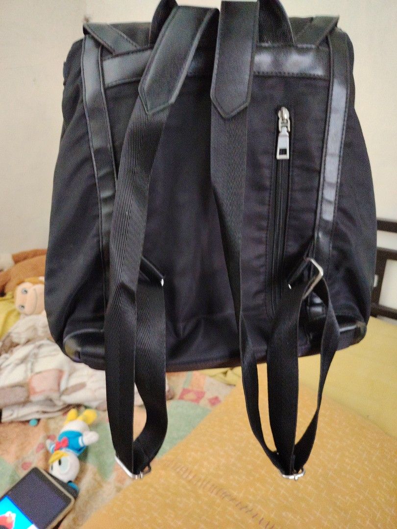 Black Backpack with Silver Hardware (Category: Backpacks) located in Taguig. Submitted by roxie0419 (Listing ID 1438499429, Image 3). Description: - Black backpack - Flap closure with silver hardware - Top handle - Adjustable shoulder straps - Zippered back pocket - Nylon-like material with leather accents SF c/o buyer MOP GCash or Maya COP via LBC.