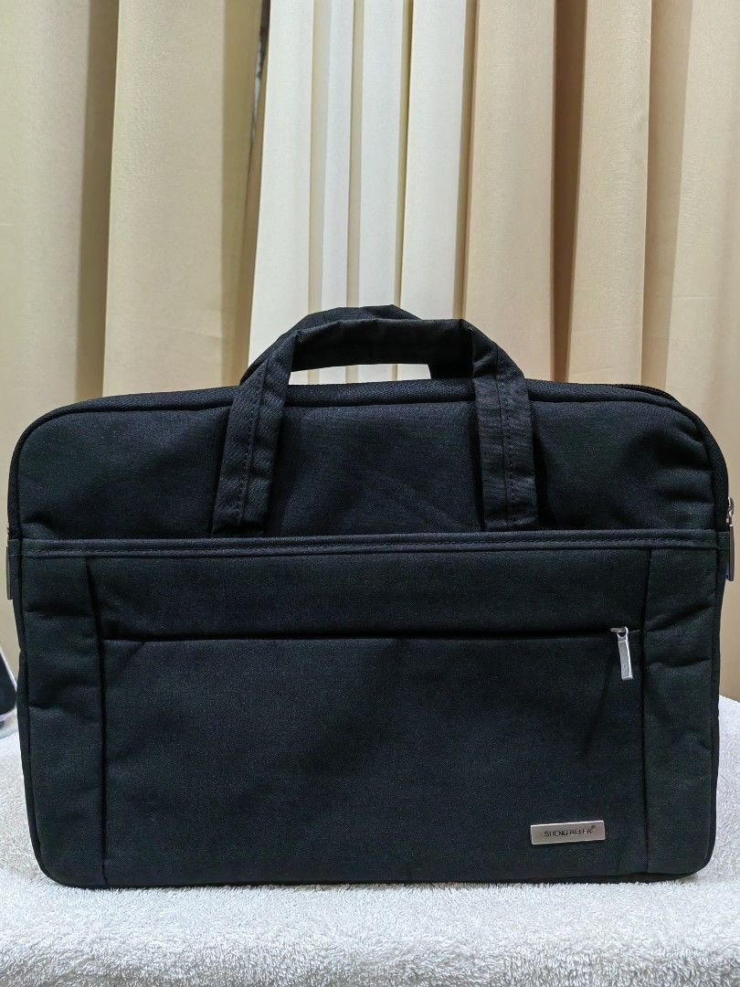 Black Laptop Bag (Category: Laptop Bags & Sleeves) located in Makati City. Submitted by prelovedtreatedwithlove (Listing ID 1438464793, Image 1). Description: - Black laptop bag - With a handle - Zippered front pocket - Main compartment - Gray interior - Made of durable material - 14 inches - no issue .