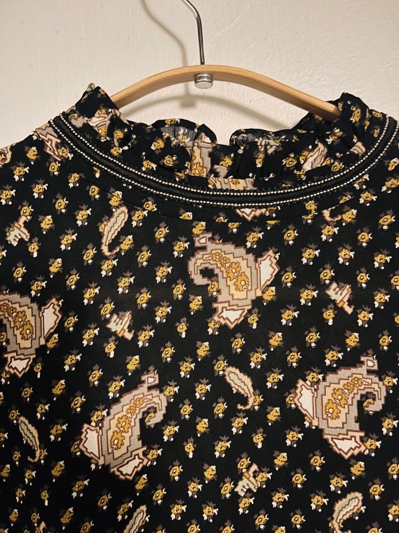 BLACK PAISLEY DRESS (Category: Dresses) located in Pasig City. Submitted by fruitselling (Listing ID 1438429008, Image 3). Description: - Neckline: High ruffled or funnel mock neck lined with piping detail. - Sleeves: Long sleeves with elasticated smocked cuffs. - Waistline: Curved piping seam that drops into an elasticated smocked waist. - Skirt: Tiered A-line silhouette featuring lightweight ruffled panels. Width 17 inches Length 31 inches .