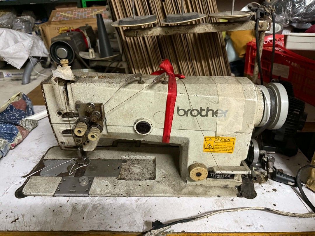Brother Industrial Sewing Machine (Category: Other Home Appliances) located in Manila. Submitted by bebekikest39865 (Listing ID 1438480342, Image 1). Description: - Brother industrial sewing machine - Model: LT2-B842-2 - Sturdy build with visible motor - Includes needle and thread guides - Features a work surface - Well-maintained condition - Ready for industrial use.