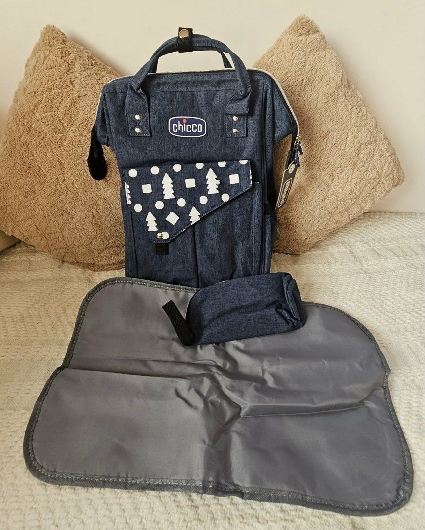 Chicco Diaper Bag with Changing Mat (Category: Diaper Bags & Wetbags) located in Manila. Submitted by thriftwitlove (Listing ID 1438423497, Image 1). Description: - Chicco diaper bag - Stylish denim design - Front pocket with tree and dot pattern - Includes matching changing mat - Includes small pouch - Top handle and adjustable straps.