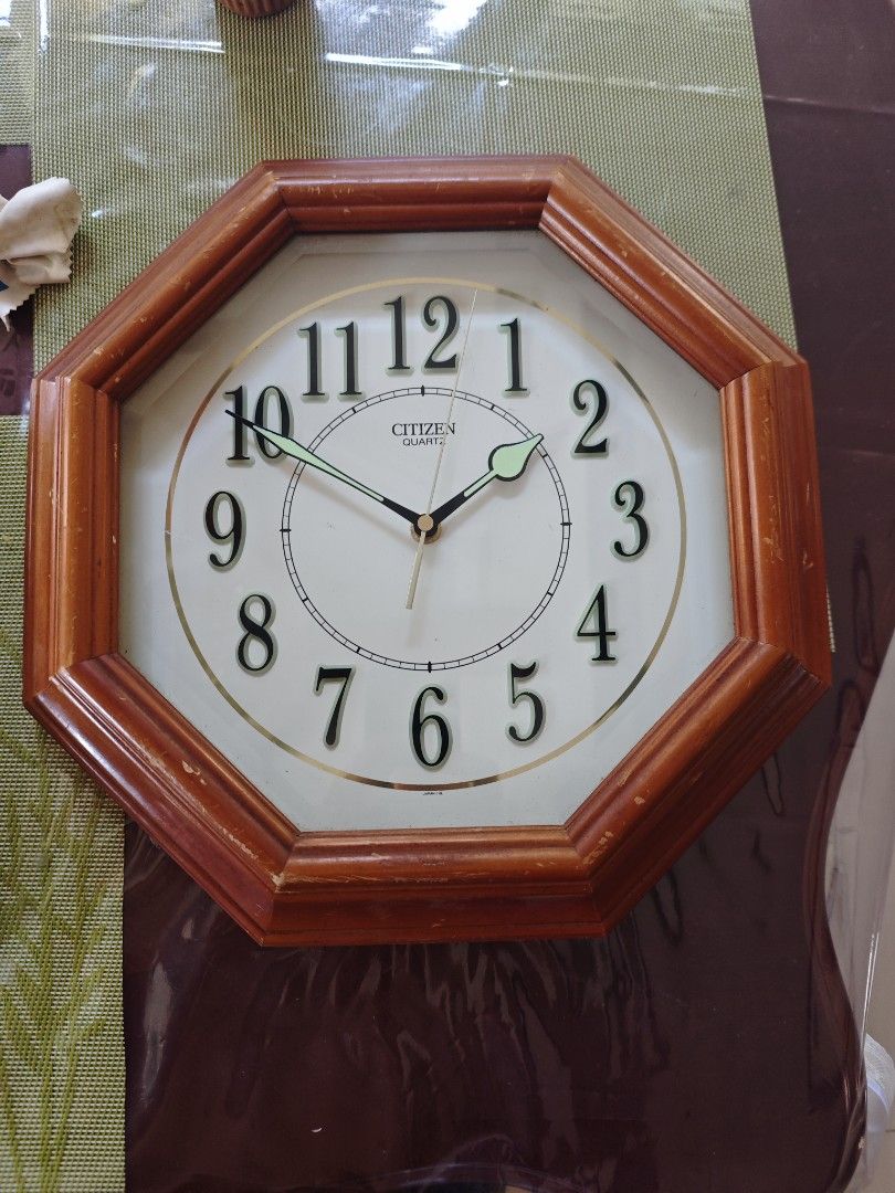 Citizen Quartz Wall Clock (Category: Clocks) located in Manila. Submitted by fdrakearon89191 (Listing ID 1438357123, Image 1). Description: - Citizen quartz wall clock - Wooden octagonal frame - White face with black numerals - Gold accents - Black clock hands with green second hand - Features Citizen logo - Classic design.