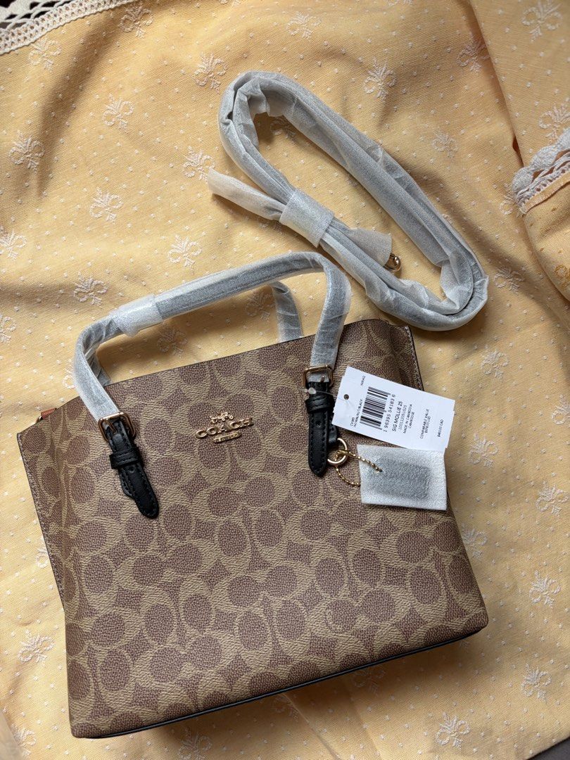 Coach Mollie tote 25 (Category: Luxury Bags & Wallets) located in Manila. Submitted by samgubaton (Listing ID 1438329047, Image 2). Description: - Authentic Coach Tote bag - Signature print - New and unused - Top handle and detachable shoulder strap - Zip closure - Gold-tone hardware - Includes dust bag - Original tags.