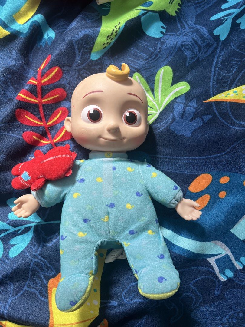 Cocomelon JJ Plush Doll (Category: Plushies & Soft Toys) located in Manila. Submitted by chiiiiing2 (Listing ID 1438310338, Image 1). Description: - Cocomelon JJ plush doll - Features a blue onesie with whale patterns - Smiling face and small red accessory - Soft and cuddly material - Ideal for young children - 2020 Moonbug product.