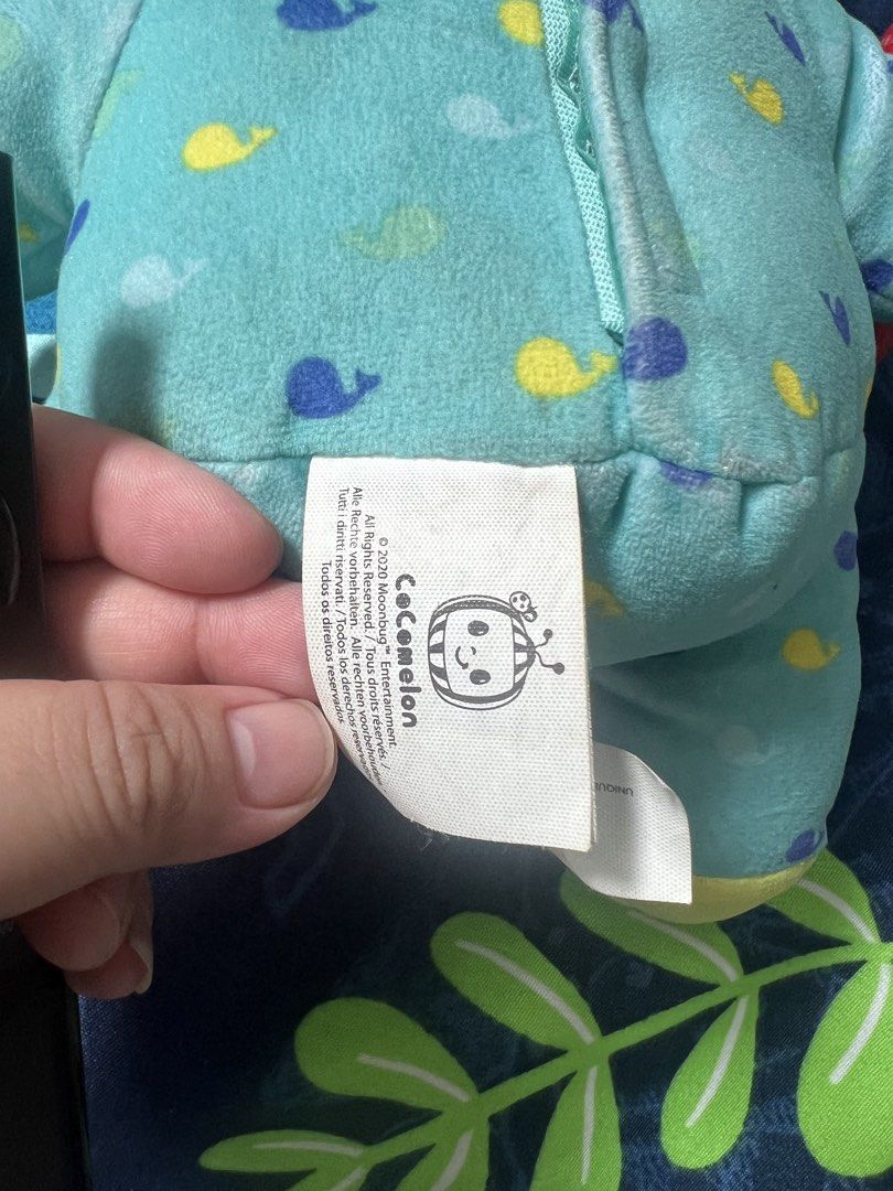 Cocomelon JJ Plush Doll (Category: Plushies & Soft Toys) located in Manila. Submitted by chiiiiing2 (Listing ID 1438310338, Image 2). Description: - Cocomelon JJ plush doll - Features a blue onesie with whale patterns - Smiling face and small red accessory - Soft and cuddly material - Ideal for young children - 2020 Moonbug product.