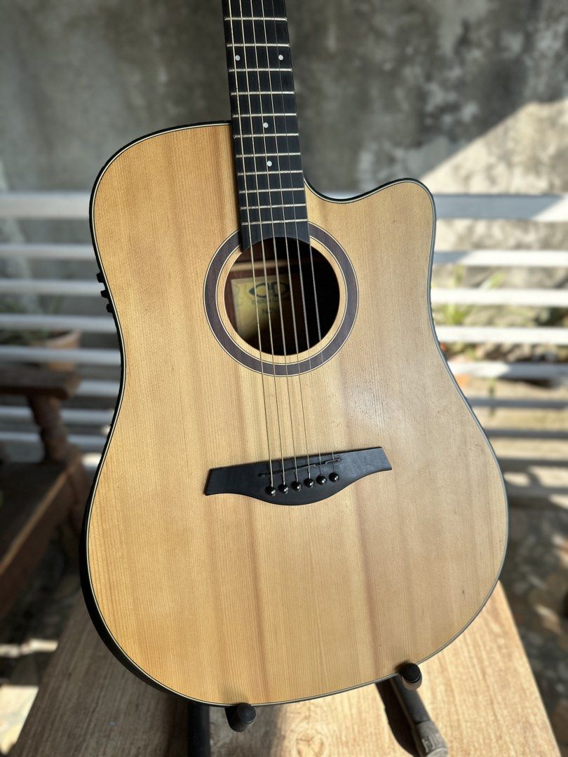 D&D Nova Acoustic-Electric Guitar (Category: Musical Instruments) located in Dagupan City. Submitted by fonsomatthy (Listing ID 1438386736, Image 2). Description: ‼️FOR SALE‼️ 👉🏻 D&D Nova Acoustic Guitar ✅ Natural wood finish ✅ Cutaway design for easy fret access ✅ Unique headstock logo ✅ Well-maintained condition ✅ Visible strings and tuning pegs ✅ Dark wood back finish ✅ Includes guitar stand Reason for selling: Di na nagagamit Issues: No maj